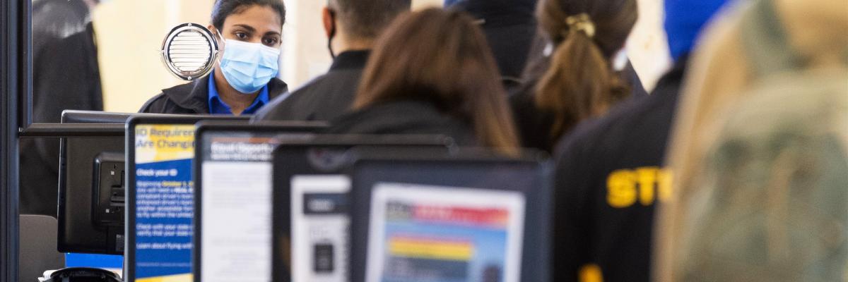 A TSA agent checks travelers through security at John Wayne Airport in Santa Ana, Calif., on Tuesday, January 26, 2021.MediaNews Group / via Getty Images