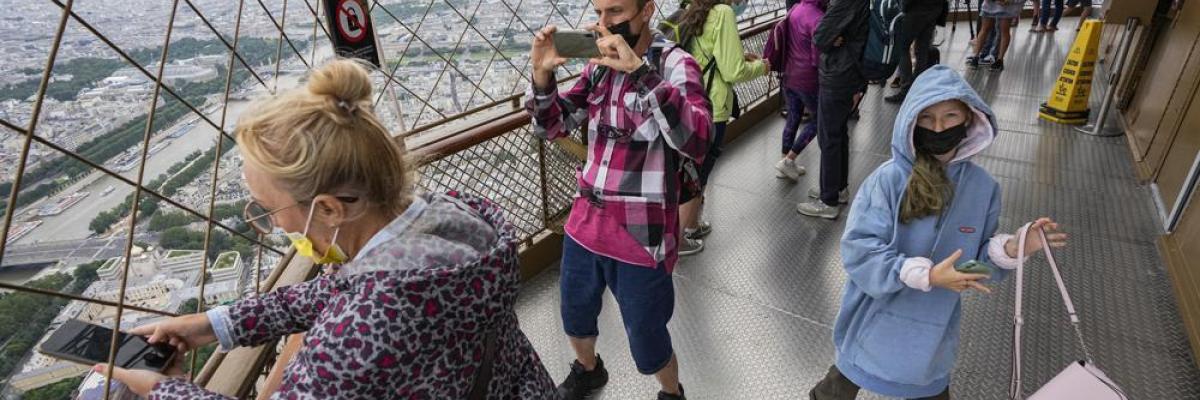 In this Friday, July 16, 2021 file photo, visitors enjoy the view from top of the Eiffel Tower in Paris. The European Union is expected to recommend that its member states reinstate restrictions on tourists from the U.S. because of rising coronavirus infection levels in the country, EU diplomats said Monday, Aug. 30. (AP Photo/Michel Euler, File)