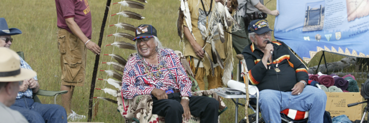 Nez Perce tribe members and NPS Rangers sit together during a commemoration of the Nez Perce Trail. (Photo/National Park Service)