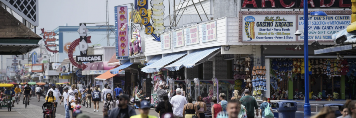 Visitors stroll past arcades on the boardwalk in Wildwood, N.J., Friday, August 9, 2024. (AP Photo/Matt Rourke)