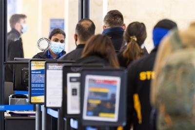 A TSA agent checks travelers through security at John Wayne Airport in Santa Ana, Calif., on Tuesday, January 26, 2021.MediaNews Group / via Getty Images