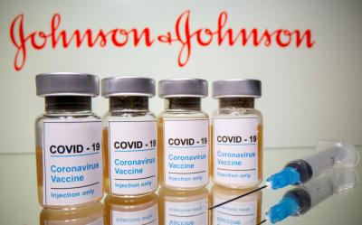 Vials with a sticker reading, "COVID-19 / Coronavirus vaccine / Injection only" and a medical syringe are seen in front of a displayed Johnson & Johnson logo in this illustration taken October 31, 2020. REUTERS/Dado Ruvic/Illustration