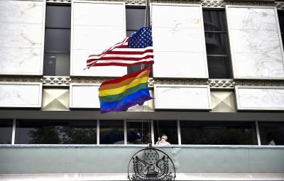 A U.S. Marine raises the U.S. flag and Pride flag to half-mast, following a mass shooting at an Orlando nightclub, at the U.S. Embassy in Mexico City on June 13, 2016. YURI CORTEZ/AFP VIA GETTY IMAGES