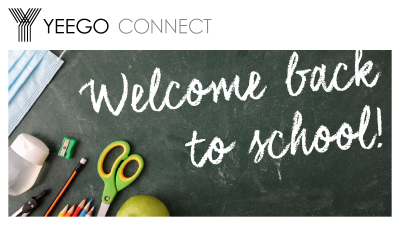 School supplies and masks with welcome back to school message in chalk font on a chalkboard. 