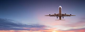 Commercial airplane jetliner flying above dramatic clouds. Photo by Lukas Gojda