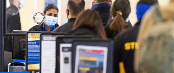 A TSA agent checks travelers through security at John Wayne Airport in Santa Ana, Calif., on Tuesday, January 26, 2021.MediaNews Group / via Getty Images