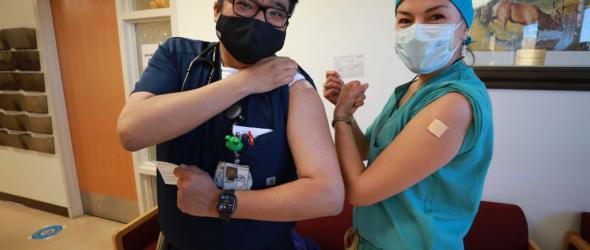 A Navajo doctor and patient pose for photos after receiving their COVID-19 vaccines at Northern Navajo Medical Center on December 15, 2020 in Shiprock, New Mexico. (Micah Garen/Getty Images)