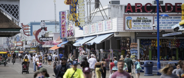 Visitors stroll past arcades on the boardwalk in Wildwood, N.J., Friday, August 9, 2024. (AP Photo/Matt Rourke)